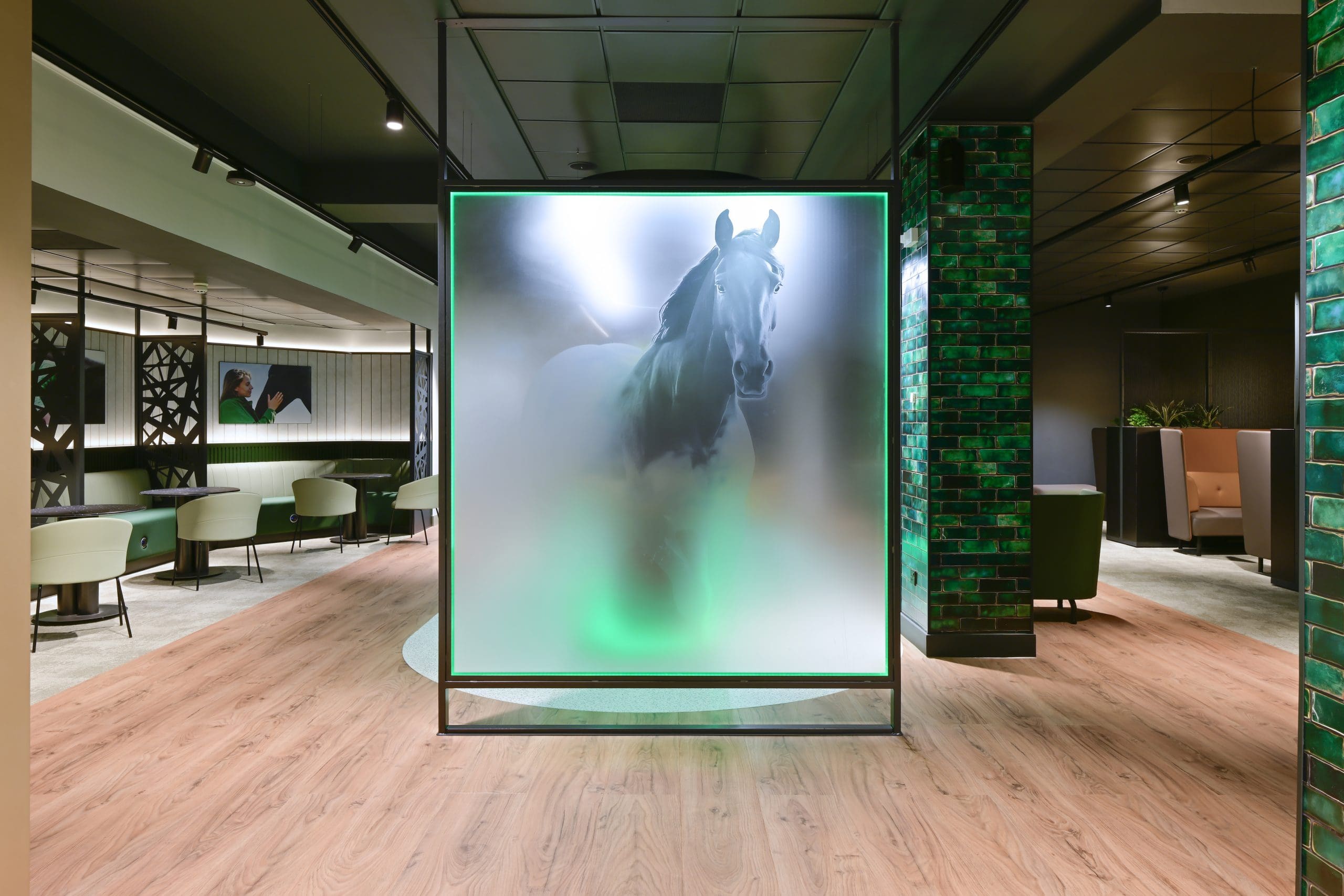 Lloyds Bank Manchester interior featuring branded glass screen with horse motif and experiential design elements